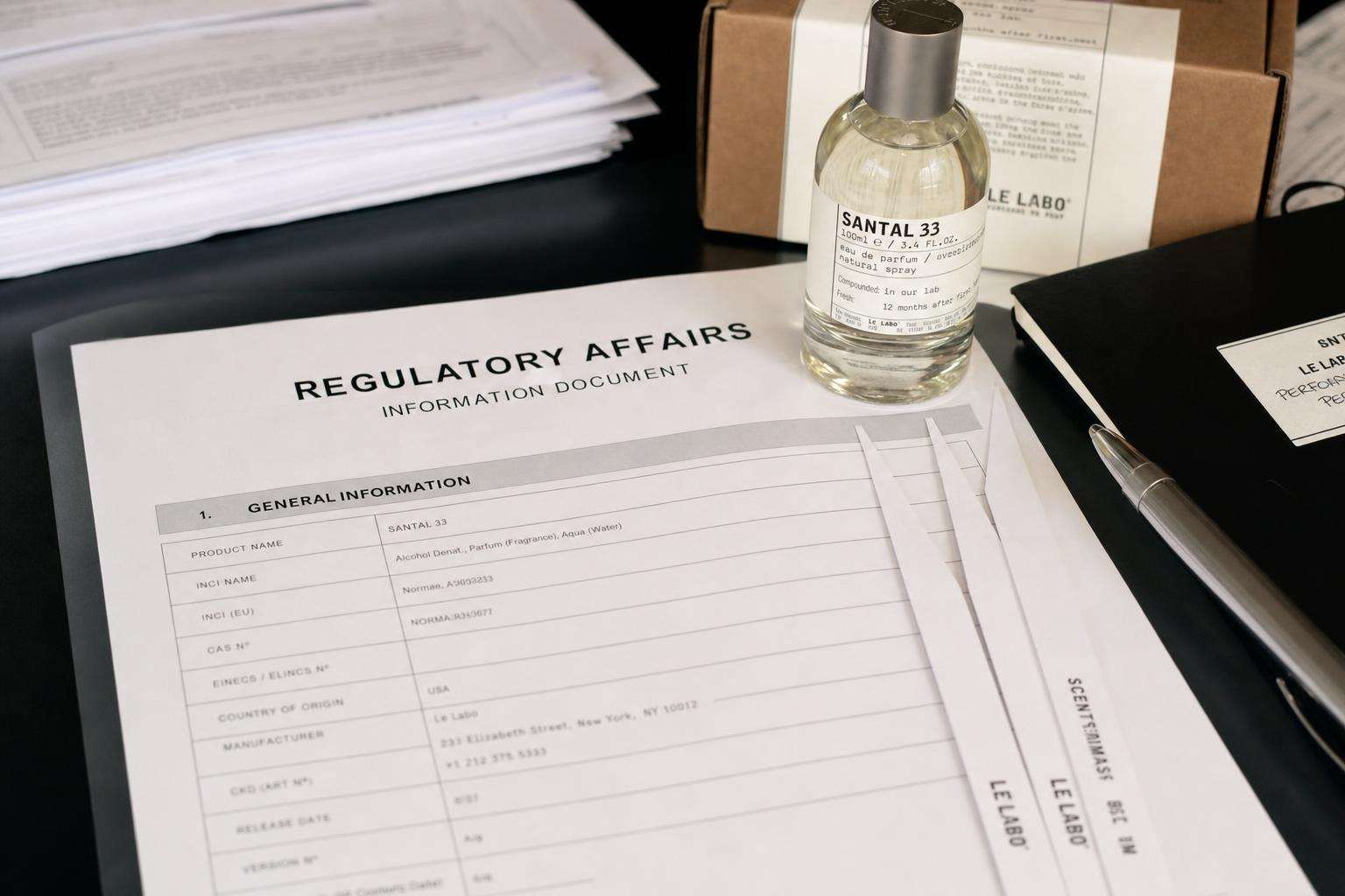 EU flag-colored document folder with cosmetics regulation text and perfume vial, no people