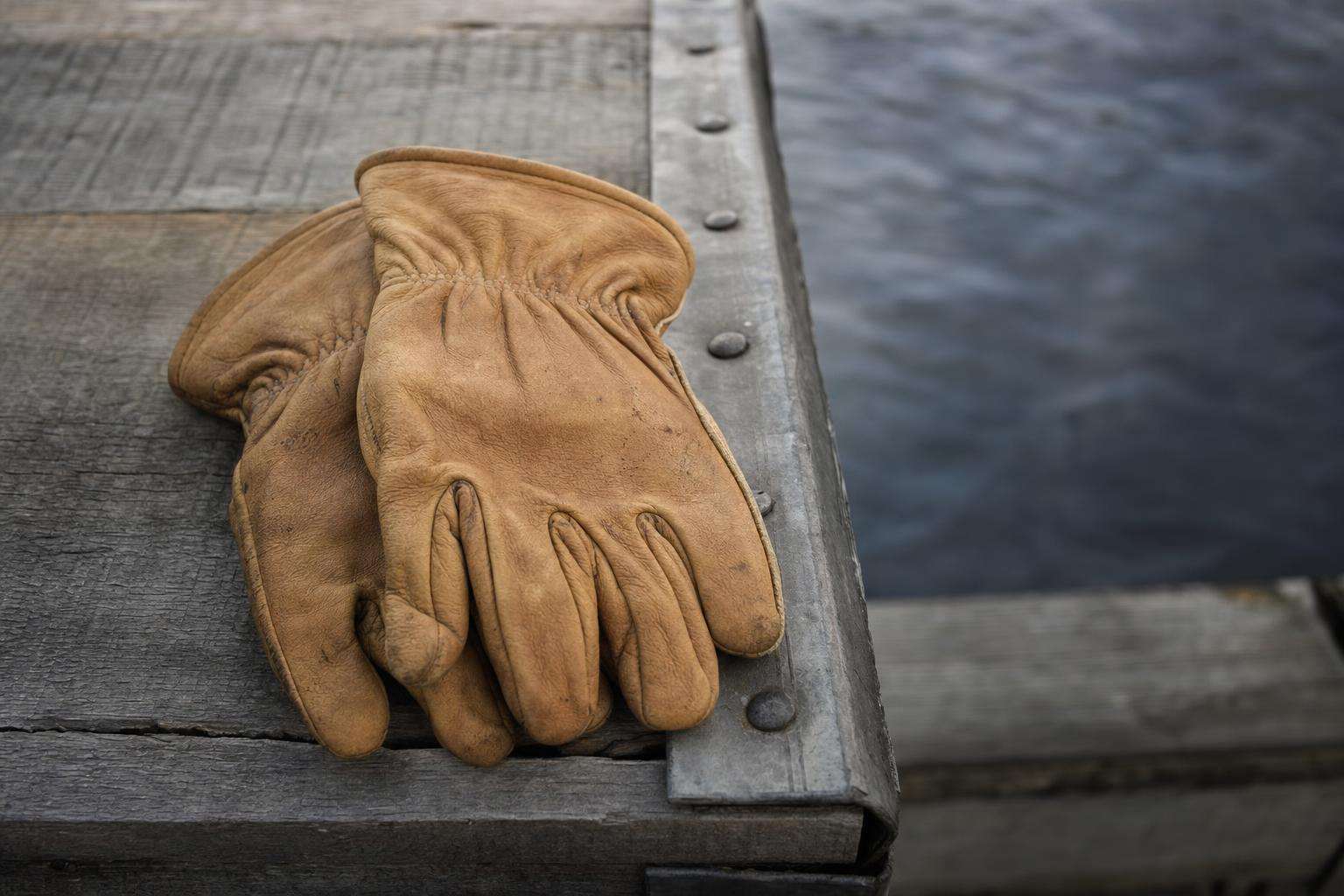 Travel backpack and work gloves conceptual still life, no people