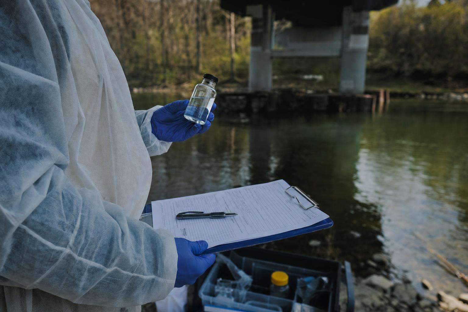 Firefighter helmet silhouette beside lab report and water glass, no people