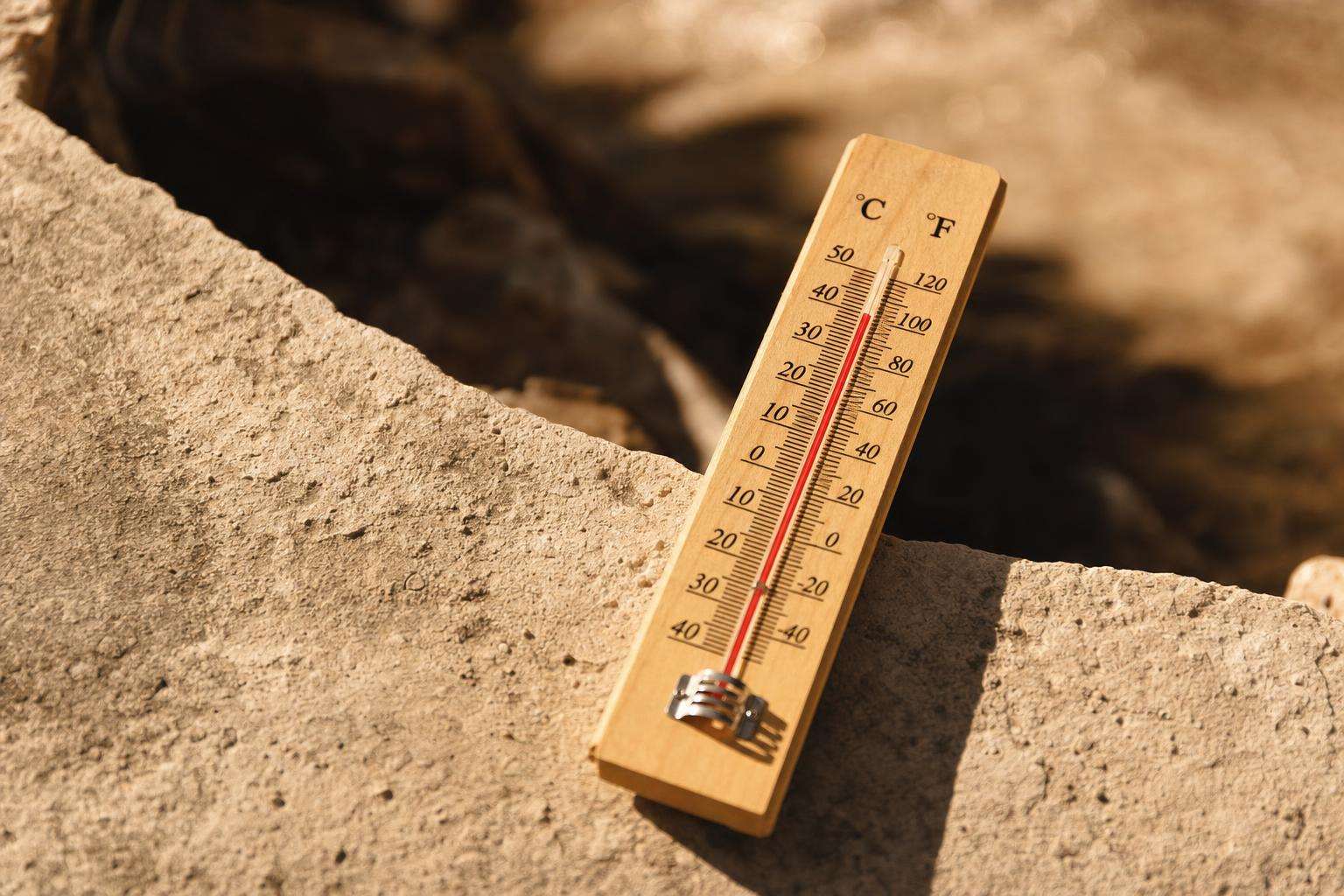 Thermometer and two sauna stove vs panel icons on wood, no people